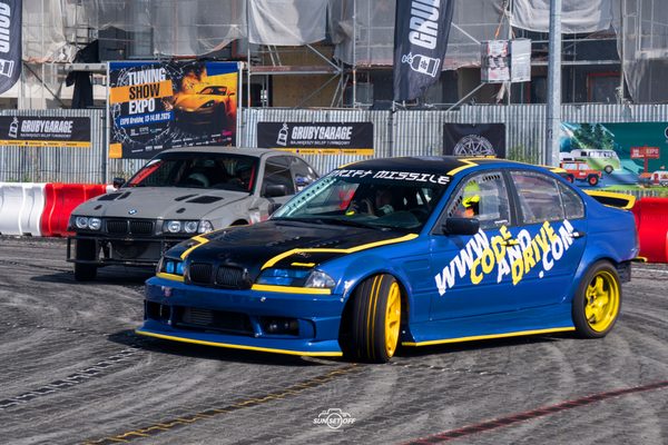 BMW E46 drifting in tandem with a white BMW E36