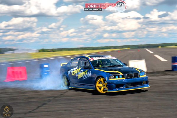 BMW E46 sliding sideways at Drift Show Podkarpacie, tyre smoke trailing behind